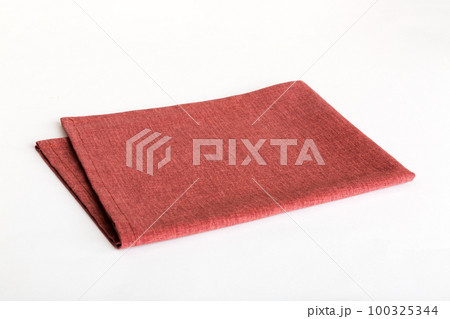 top view with red empty kitchen napkin isolated on table background. Folded cloth for mockup with copy space, Flat lay. Minimal style top view with red empty kitchen napkin isolated on table background. Folded cloth for mockup with copy space, Flat lay. Minimal style 100325344