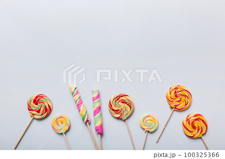 Set of colorful lollipops on colored background. Summer concept. Party Happy Birthday or Minimalist Concept Set of colorful lollipops on colored background. Summer concept. Party Happy Birthday or Minimalist Concept 100325366