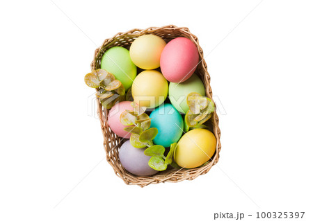Basket of colorful Easter eggs isolated on white background. Easter basket filled with colored eggs top view holiday concept 100325397