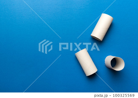 Flat lay composition with empty toilet paper rolls and space for text on color background. Recyclable paper tube with metal plug end made of kraft paper or cardboard Flat lay composition with empty toilet paper rolls and space for text on color background. Recyclable paper tube with metal plug end made of kraft paper or cardboard 100325569