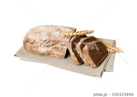 Assortment of freshly sliced baked bread with napkin isolated on white background. Healthy unleavened bread. French bread slice Assortment of freshly sliced baked bread with napkin isolated on white background. Healthy unleavened bread. French bread slice 100325600