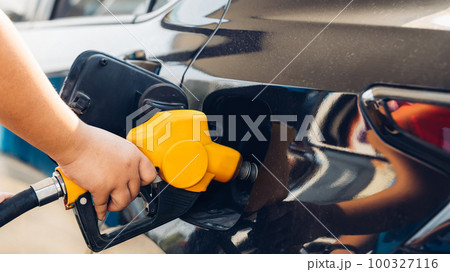 Man Refill and filling Oil Gas Fuel at station. 100327116