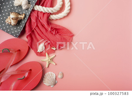 Flip flops and beach bag with shells and starfishes on pink background mockup Flip flops and beach bag with shells and starfishes on pink background mockup 100327583