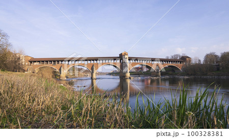 Low angle view of Ponte Coperto Pavia (covered bridge) at sunny day Low angle view of Ponte Coperto Pavia (covered bridge) at sunny day 100328381
