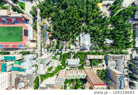 Aerial city view with crossroads and roads, houses, buildings, parks and parking lots. Sunny summer panoramic image 100328683