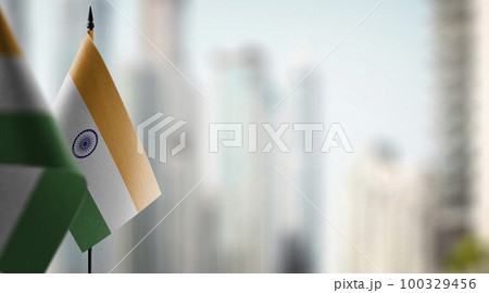 Small flags of the India on an abstract blurry background 100329456