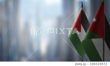 Small flags of the Jordan on an abstract blurry background Small flags of the Jordan on an abstract blurry background 100329472