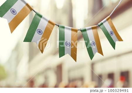 A garland of India national flags on an abstract blurred background 100329491