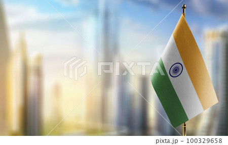 Small flags of the India on an abstract blurry background 100329658