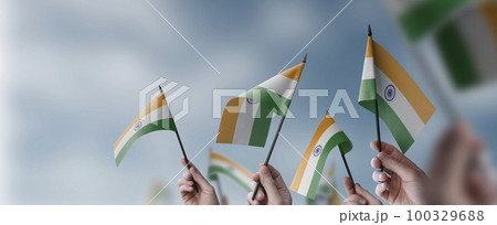 A group of people holding small flags of the India in their hands 100329688