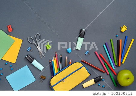 Flat lay photo of workspace desk with school accessories or office supplies on gray background. Flat lay photo of workspace desk with school accessories or office supplies on gray background. 100330213