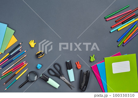 Flat lay photo of workspace desk with school accessories or office supplies on gray background. Flat lay photo of workspace desk with school accessories or office supplies on gray background. 100330310