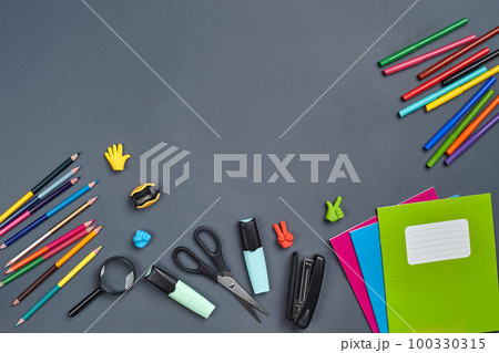 Flat lay photo of workspace desk with school accessories or office supplies on gray background. Flat lay photo of workspace desk with school accessories or office supplies on gray background. 100330315