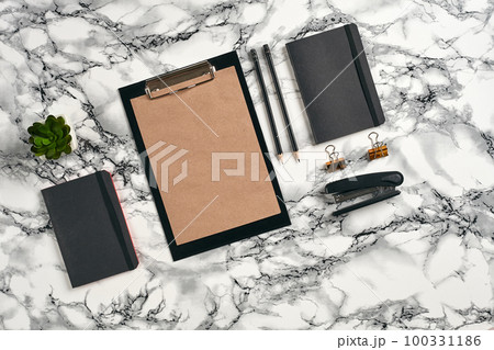 Top view in focus with different office equipment, supplies, stationery. Marble table with copy space. Education, workplace background. Close-up. 100331186