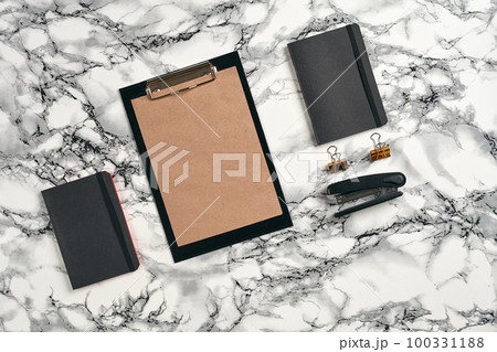 Top view in focus with different office equipment, supplies, stationery. Marble table with copy space. Education, workplace background. Close-up. 100331188