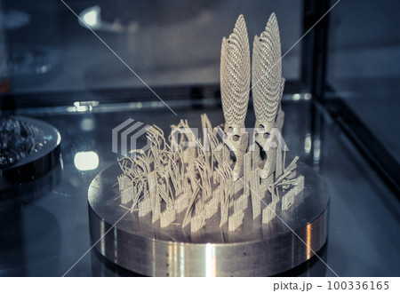 Object printed on metal 3d printer close-up. Object printed in laser sintering machine. Modern 3D printer printing from metal powder. Concept progressive additive DMLS, SLM, SLS 3d printing technology 100336165