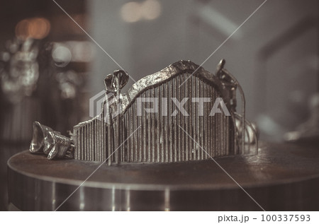 Object printed on metal 3d printer close-up. Object printed in laser sintering machine. Modern 3D printer printing from metal powder. Concept progressive additive DMLS, SLM, SLS 3d printing technology 100337593