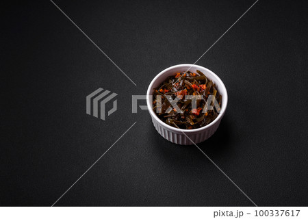 Delicious marinated seaweed with paprika, spices and salt Delicious marinated seaweed with paprika, spices and salt 100337617
