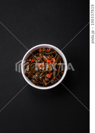 Delicious marinated seaweed with paprika, spices and salt 100337619