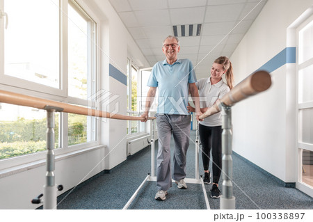 Senior Patient and physical therapist in rehabilitation walking exercises 100338897