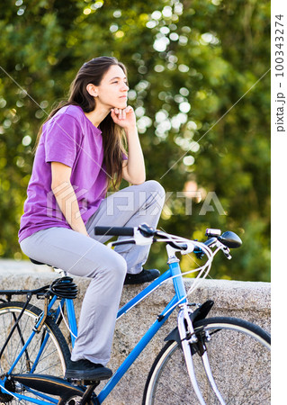 Bicycle sustainability, healthy lifestyle for mental health wellness. latin uruguayan mid woman 100343274