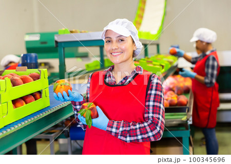 Portrait of glad woman with peaches Portrait of glad woman with peaches 100345696