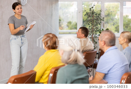 Young female teacher explaining subject to mature students Young female teacher explaining subject to mature students 100346033