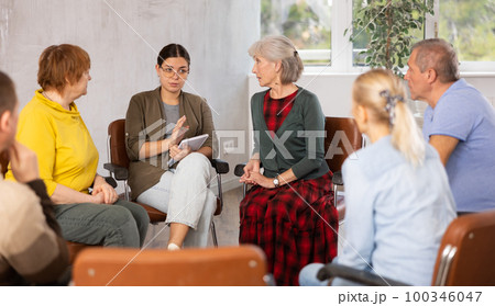 Young woman doing group training for mature people 100346047