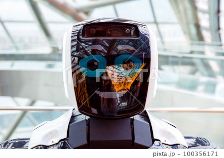 robot portrait close-up. smiling face of robot. Autonomous personal assistant robot for navigation direction in Museum Energy of Future. robot portrait close-up. smiling face of robot. Autonomous personal assistant robot for navigation direction in Museum Energy of Future. 100356171