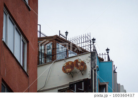 Old building with rusty satellite dishes 100360437