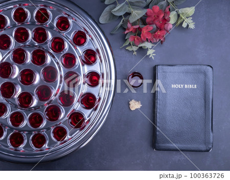 Taking communion the wine and the bread symbols on black background Taking communion the wine and the bread symbols on black background 100363726