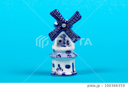 Windmill figurine from Holland, isolated on blue 100366359