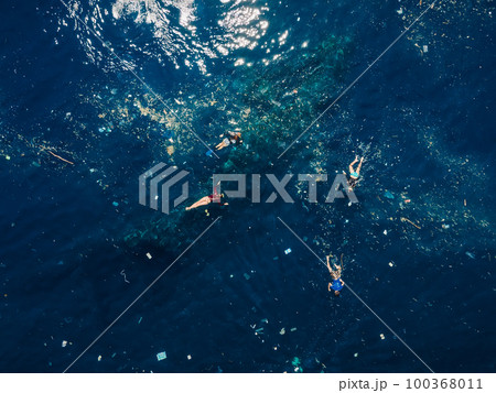 People snorkeling in plastic pollution at Liberty wreck ship in Tulamben, Bali. 100368011