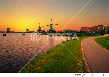 Sunset above farm houses and windmills of Zaanse Schans in the Netherlands Sunset above farm houses and windmills of Zaanse Schans in the Netherlands 100368515