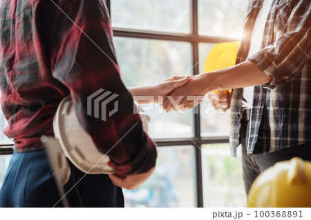 Young couple asian architects shake hands while working for teamwork. Young couple asian architects shake hands while working for teamwork. 100368891