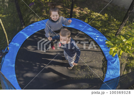 children jump on the trampoline children jump on the trampoline 100369328