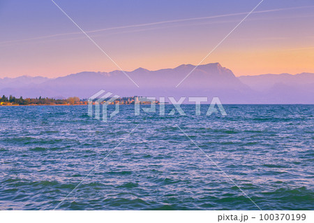 Early morning, sunrise over Lake Garda (Lago di Garda), Italy, Europe Early morning, sunrise over Lake Garda (Lago di Garda), Italy, Europe 100370199