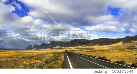 Travel in Canary islands. Impressive landscapes of volcanic Lanzarote . scenic road lead to Famara beach 100371944