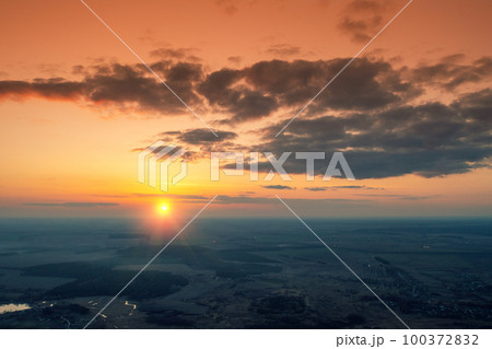 Sunset in the countryside in spring. Rural landscape in the evening. Aerial view of the countryside in evening. Panoramic view Sunset in the countryside in spring. Rural landscape in the evening. Aerial view of the countryside in evening. Panoramic view 100372832