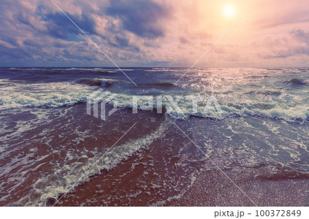 Seascape in the early morning. Sunrise over the stormy sea. Nature landscape 100372849