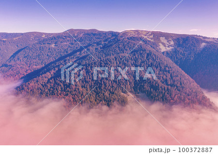 Fantastic view of the tops of the mountain ridge above the clouds 100372887