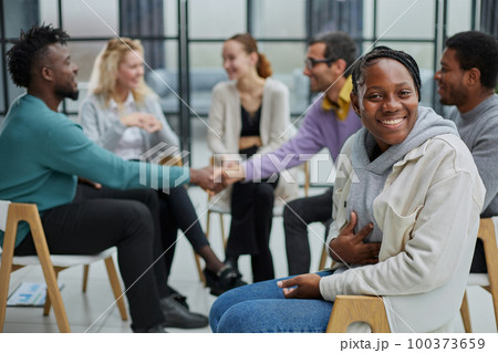 Successful manager or team leader sitting in front of his colleagues Successful manager or team leader sitting in front of his colleagues 100373659