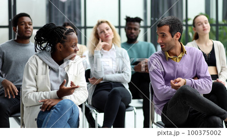 young people shaking hands in a circle of like-minded people 100375002