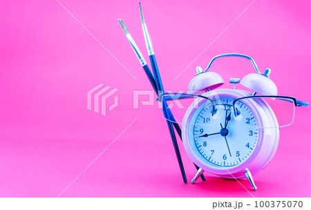 Concept Education or business Alarm clock and teacher glasses Business objects isolated on colorful pink paper background, Back to school concept 100375070