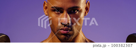 Close up of man doing exercise with weight dumbbells on studio background. Strength and motivation 100382307