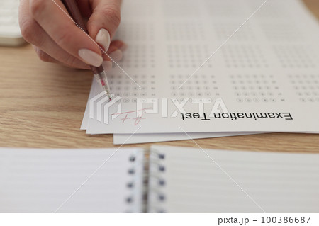 Hand with pen on examination test paper with excellent mark close up. Hand with pen on examination test paper with excellent mark close up. 100386687