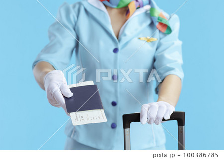 Closeup on stylish female flight attendant on blue Closeup on stylish female flight attendant on blue 100386785