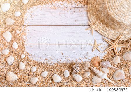 Sand seashells background. Summer time concept with sea shells and starfish on wooden background and sand 100386972