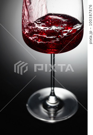 Closeup of red wine pouring. 100387876
