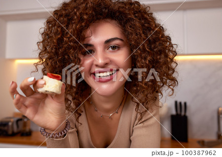 Young woman eating sushi asian food and noodles using choopsticks from take away delivery 100387962